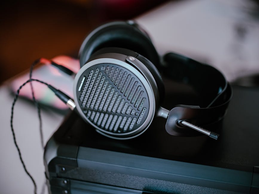 Close-up of professional headphones on a desk, featuring intricate design and modern audio technology.